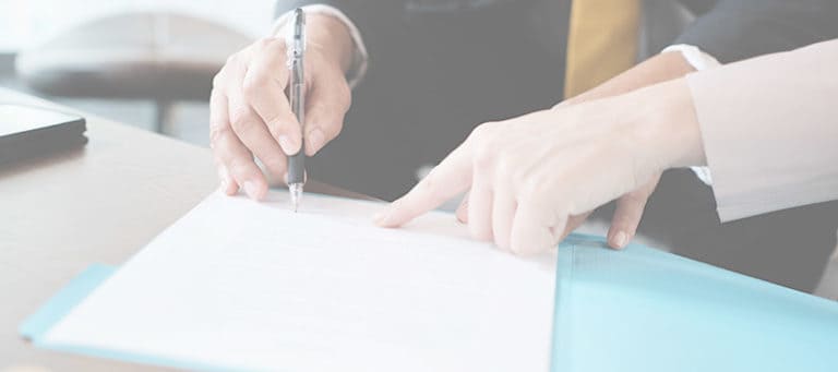 A person signing a document.