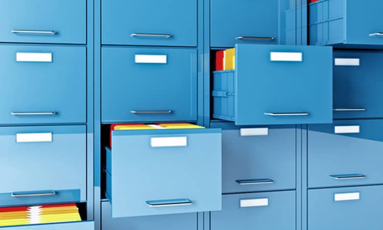 Blue file cabinets with some drawers open.