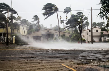 Hurricane with flooding and heaving wind in front of building.