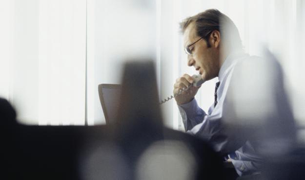 A businessman on the phone in the office.